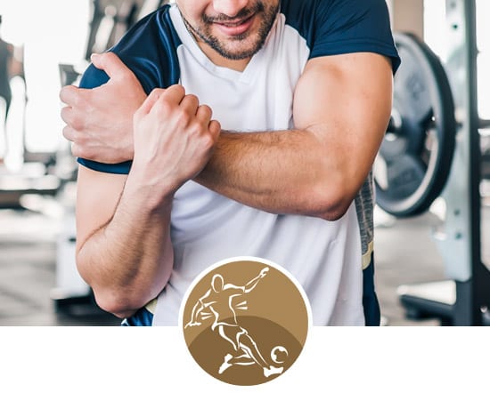 York Chiropractic Center | a man in a gym holding his shoulder in pain after working out