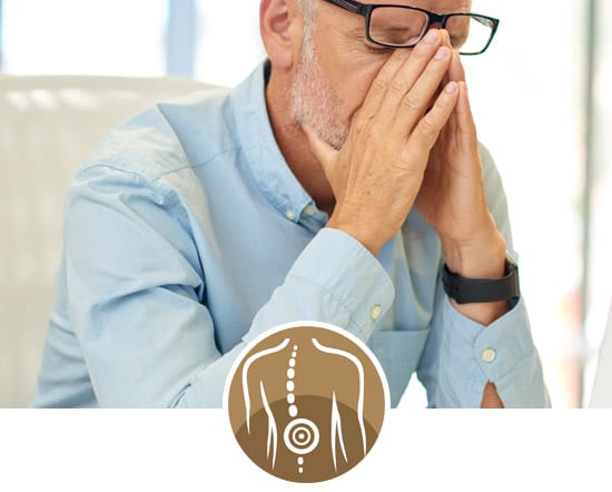 York Chiropractic Center | a man wearing glasses and long-sleeved shirt holding his nose and leaning over in pain